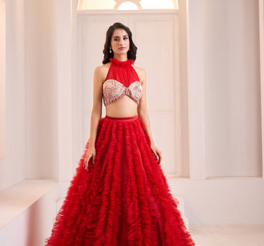 Red Embroidered Halter Neck Mashru Blouse with Ruffle Lehenga and Potli Bag