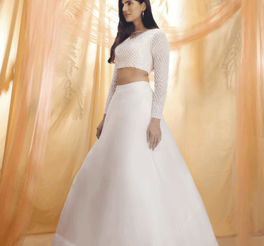 Off White Lehenga With An Embroidered Blouse