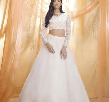 Off White Lehenga With An Embroidered Blouse