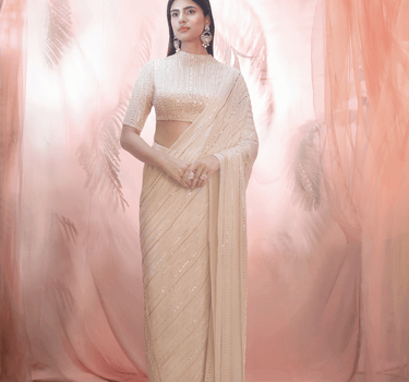 Golden Saree With An Elbow Sleeve Blouse